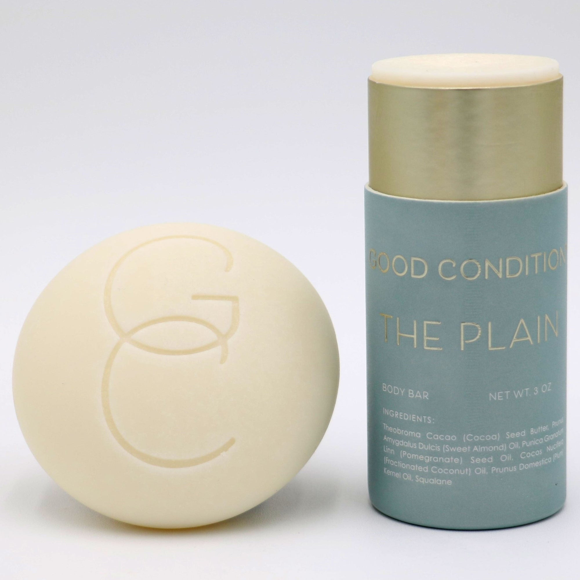 Good Condition The Plain organic cocoa butter body moisturizer tube. Made with sweet almond oil, pomegranate seed oil, plum kernel oil and squalane. Plastic free and hand made in small batches.